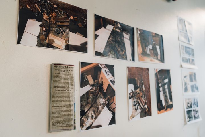 Wall of a rehearsal room with pictures of historical research about Don Juan Comes Back from the War
