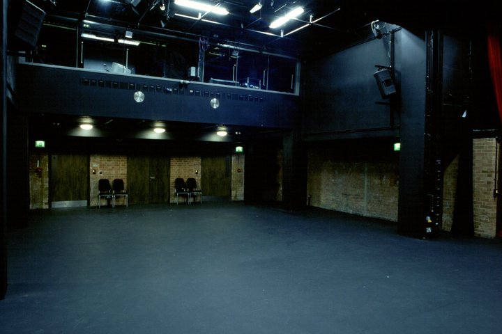 empty GBS Theatre at RADA showing a few chairs and lighting box