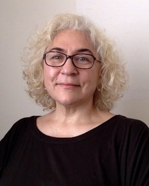 Portrait, head and shoulders image of Irina Brown smiling.