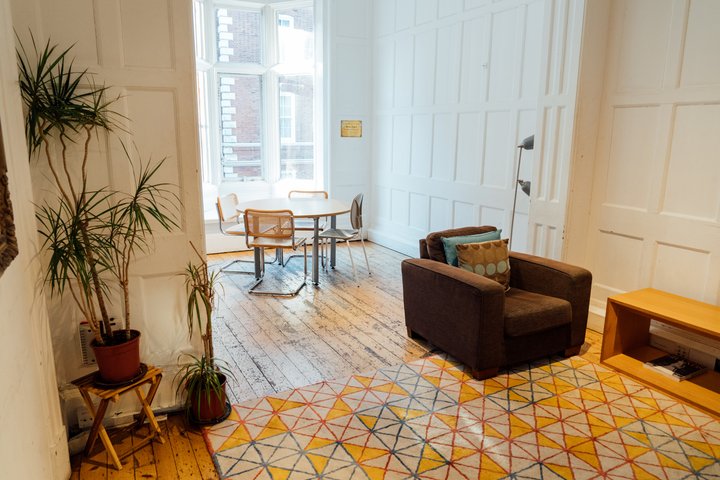 A room with high ceilings and wooden floors.