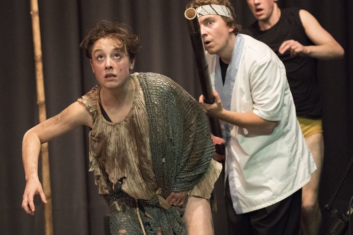 Actress Lucie Sword playing Caliban in The Tempest in a touring RADA production to schools, standing with two other actors