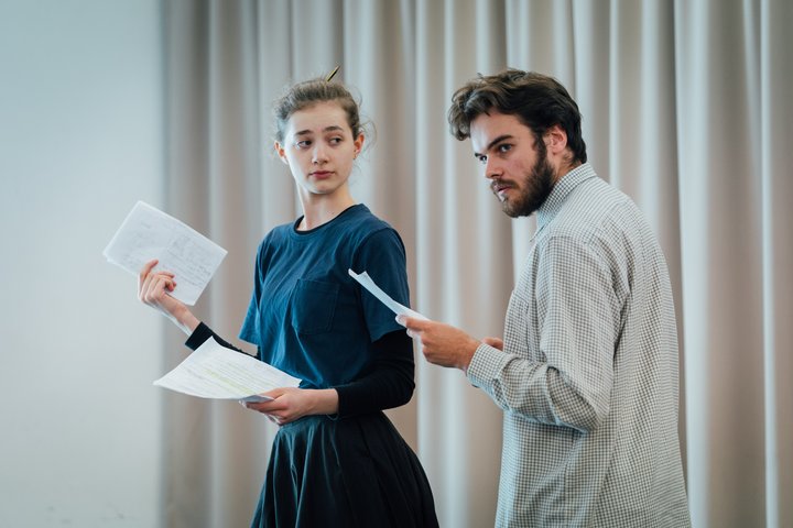 Two actors rehearse together.