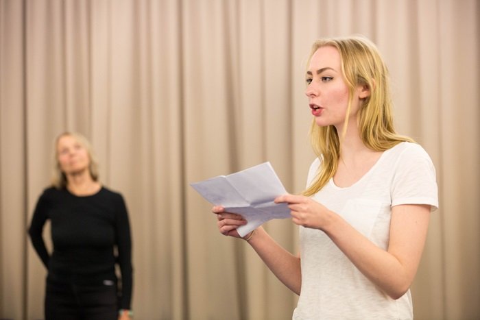Student rehearses a Shakespeare speech with script with assessor watching