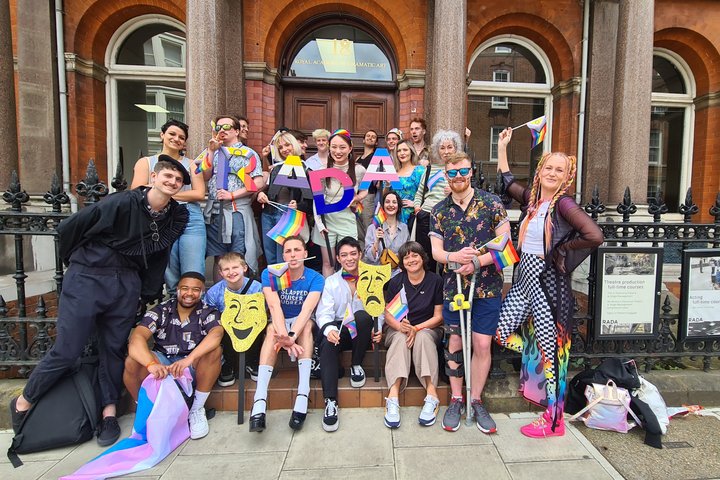 A celebratory group of RADA students outside the RADA building getting ready to march at London's Pride Parade
