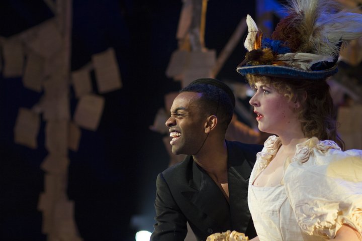 two actors in Shakespeare's As You Like It in costume wearing extravagant hats