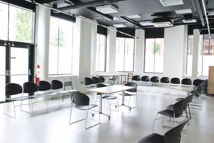 empty GBS Studio with chairs round the sides of room and central table and chairs