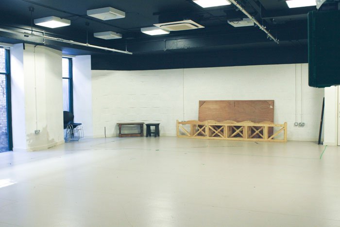 empty Jerwood Vanbrugh studio with benches and stacked chairs