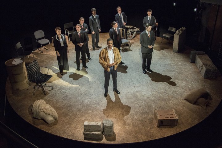 students on stage in a scene from Stuff Happens in the Jerwood Vanbrugh Theatre