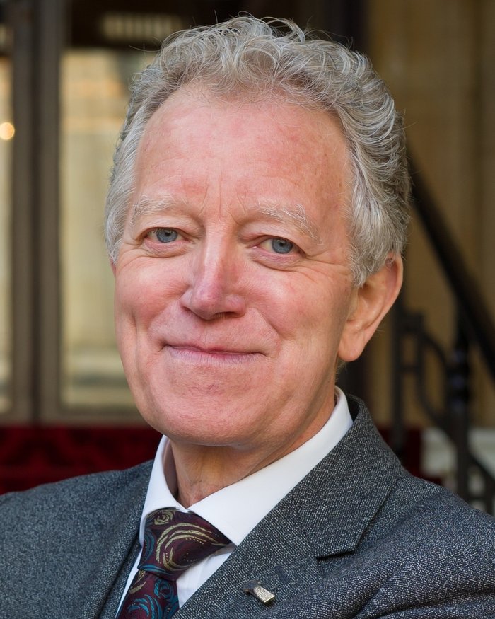 Head and shoulders image of Richard Middleton smiling directly at the camera in natural lighting.